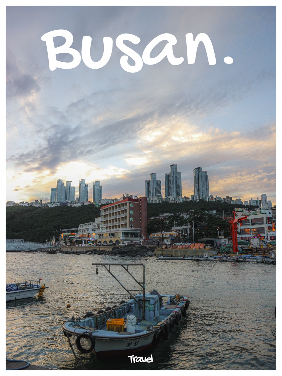 The word Busan in a rounded handwritten font above a harbour and city skyline